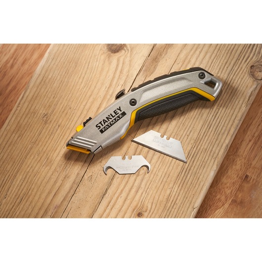 Photo of STANLEY 0-10-789 utility knife and two spare blades on wooden surface.