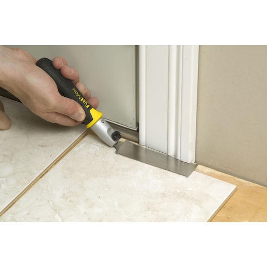STANLEY 0-20-331 pull saw used to cut door frame at floor level, shown during tile installation.