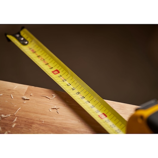 STANLEY 0-33-811 yellow tape measure photography close-up on wood surface.