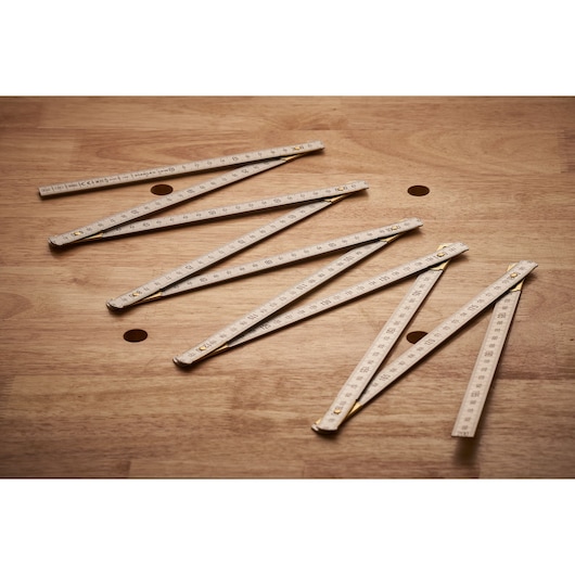 STANLEY 0-35-305 folding ruler, white with black markings, shown extended on a wooden surface.