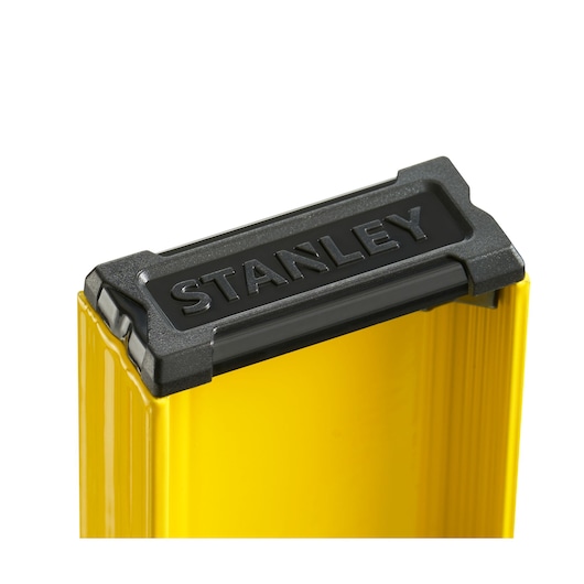 STANLEY 0-42-074 photography of yellow level tool top corner with black and gray plastic end cap, close-up.