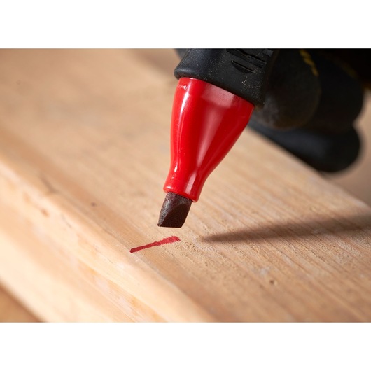 STANLEY 0-47-315 red marking pen drawing a line on wood, close-up photography.