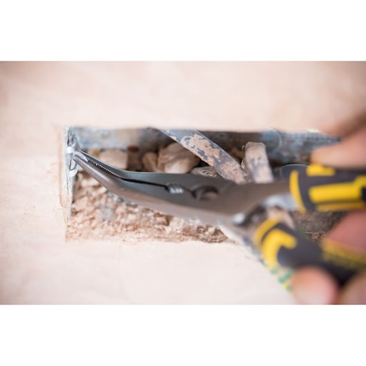 Stanley 0-89-872 pliers gripping wire in electrical box, close-up, photography of hand tool usage.