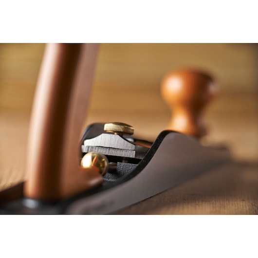 STANLEY 1-12-137 woodworking hand plane with wood handles, close-up side view.