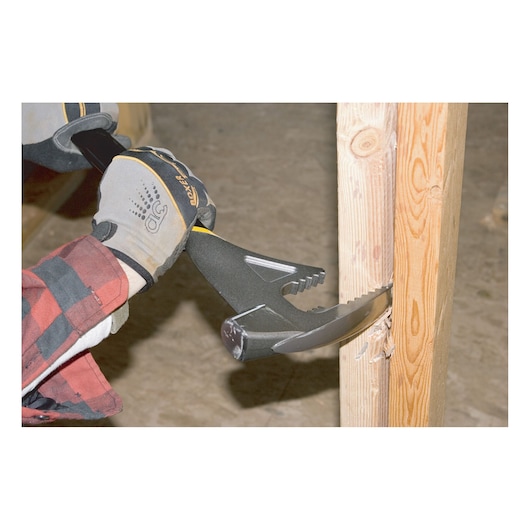 Photo of a STANLEY 1-55-099 demolition tool being used to pull wood from a timber post, close-up action view.