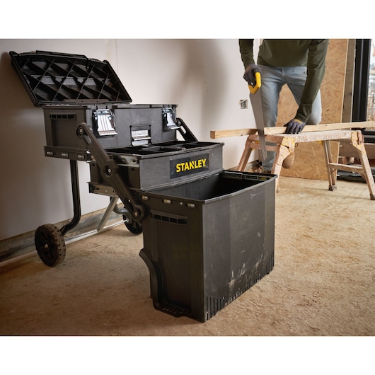 Photo of STANLEY 1-94-210 mobile toolbox with open compartments in a workshop setting.