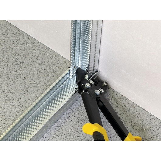 STANLEY 15-273 metal cutting tool in use on steel stud corner, close-up photography.