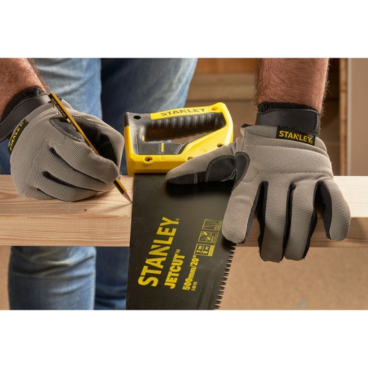 STANLEY 2-20-151 hand saw and gloves marking wood, close-up photography.