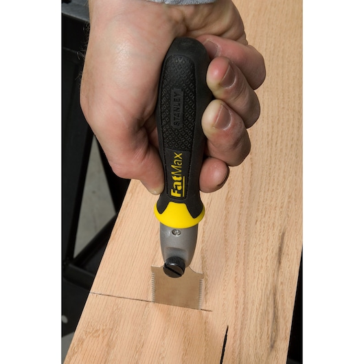 STANLEY 3-20-331 marking gauge FatMax used to scribe wood, close-up of hand holding tool.