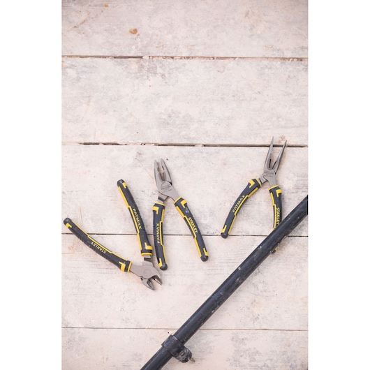 STANLEY 4-84-488 plier set with black and yellow handles, flat lay on wooden surface.
