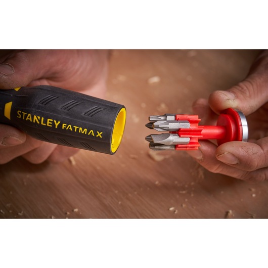 STANLEY FATMAX FMHT0-62691 screwdriver handle with yellow inner, showing red bit holder with multiple bits, close-up.