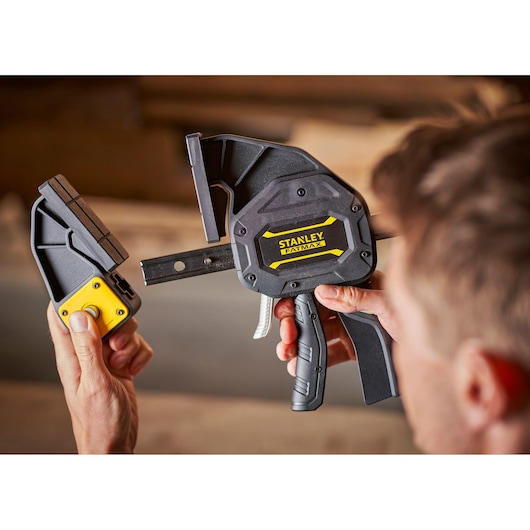Photo of STANLEY FMHT0-83239 heavy-duty clamp in use, close-up view showing tool and detachable part.