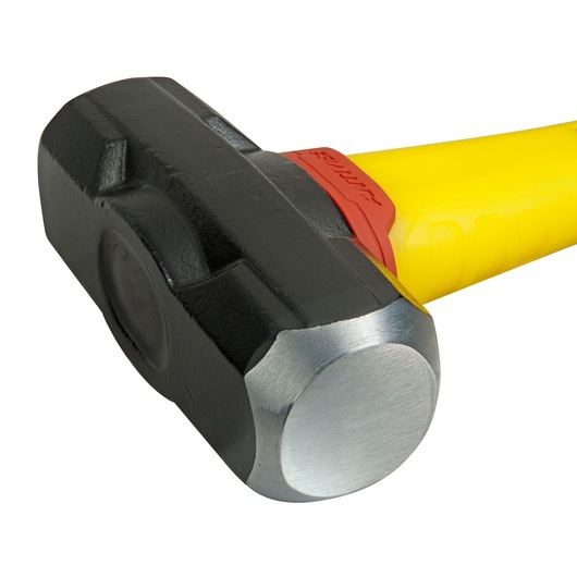 Close-up of a STANLEY sledgehammer with a black head and yellow handle.