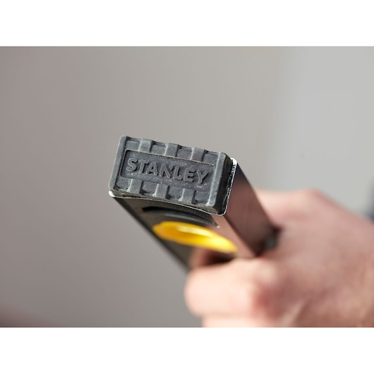 Photo of STANLEY FMHT42554-1 hand tool with black rubber end and STANLEY logo held in hand.