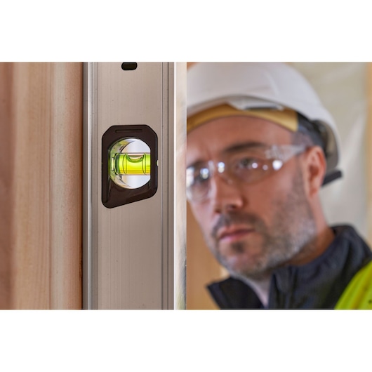 STANLEY FMHT43680-1 photography of a spirit level with green vial on vertical surface, close-up angle.