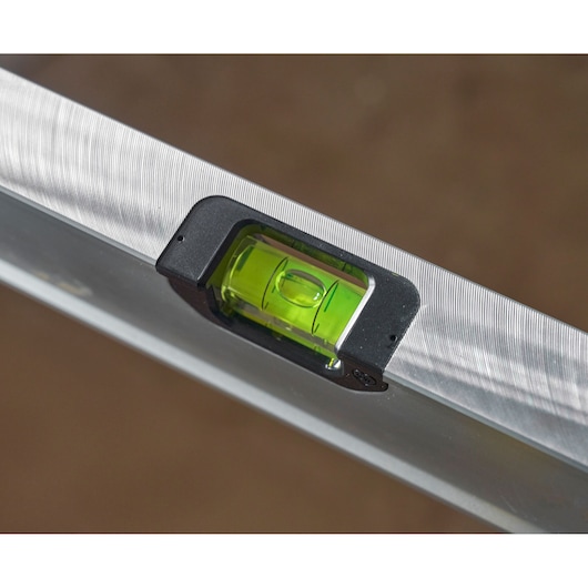 STANLEY FMHT43680-1 spirit level close-up, showing green vial and metal frame, angled view.