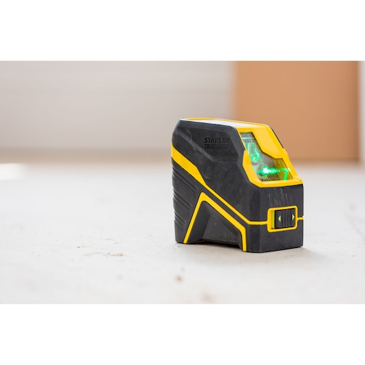 Photo of STANLEY FMHT77595-1 cross line laser level with yellow and black body, angled front view.