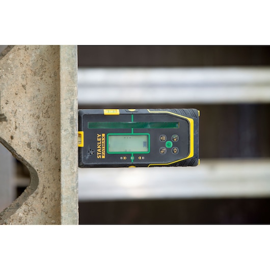 STANLEY FMHT77653-0 laser receiver with display, close-up in construction setting.