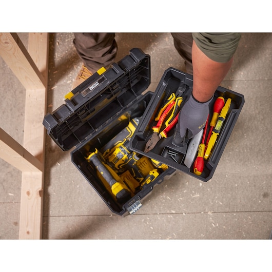 STANLEY FMST1-71971 toolbox with tray holding assorted hand tools, top view in workshop setting.