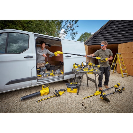 STANLEY SFMCBL7M1 power tools photography showing tools and accessories outside a van with workers.