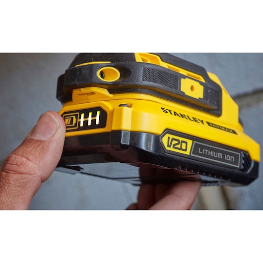 Photo of STANLEY SFMCD711D22 V20 lithium ion battery pack, close-up showing charge indicator.