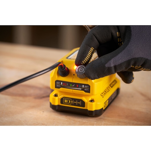 STANLEY SFMCE040B heat gun base with glove adjusting temperature knob, product close-up photo.