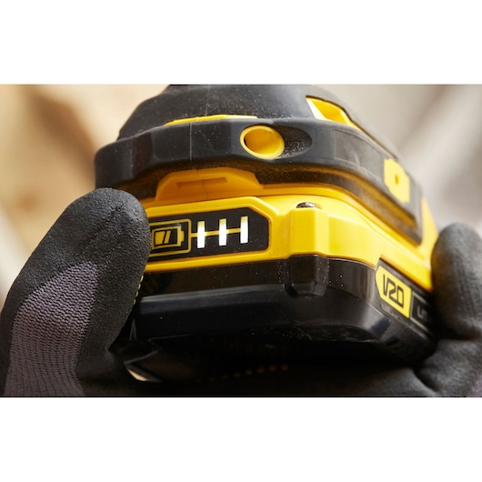 Close-up photo of STANLEY SFMCF800C2K tool battery pack with V20 label and battery indicator in use.