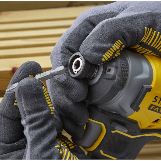 STANLEY SFMCF820D2K impact driver front angle, gloved hand inserting screwdriver bit