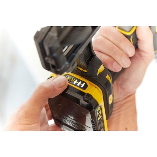 STANLEY SFMCN616B photography of yellow battery-powered tool held in hand, close-up view.
