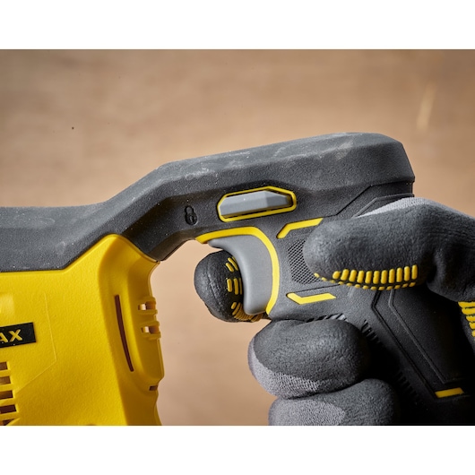 STANLEY SFMCS300D2K power tool handle close-up, black-yellow grip, operator in gloves, side angle.