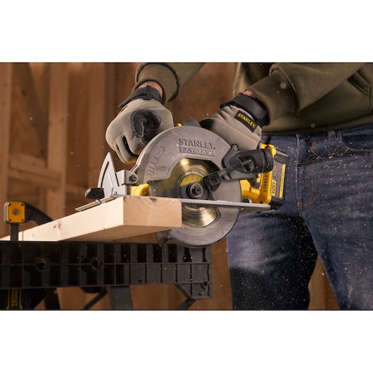 STANLEY SFMCS500M2K circular saw in use cutting wood, close-up, product photography.