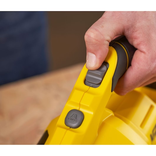 STANLEY SFMCVH001B vacuum handle close-up with gray empty indicator button and thumb on switch.