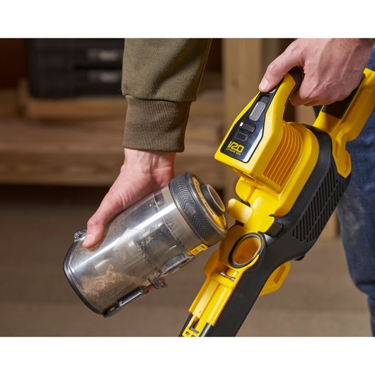 STANLEY SFMCVS001D1 cordless vacuum cleaner close-up with dust container being removed.