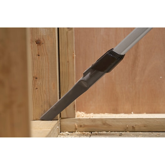STANLEY SFMCVS001D1 vacuum crevice tool cleaning corner of wooden frame, close-up photography.