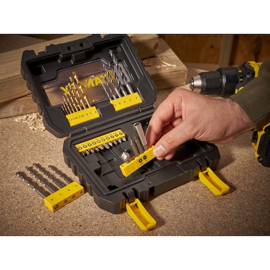STANLEY STA88550 drill and bit set case on workbench, hand selecting bit holder, photo from above.