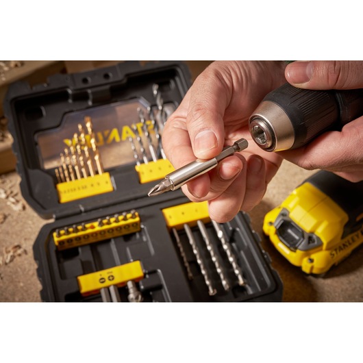 STANLEY STA88550 drill bit set case with drill, close-up of bit being inserted, photography.