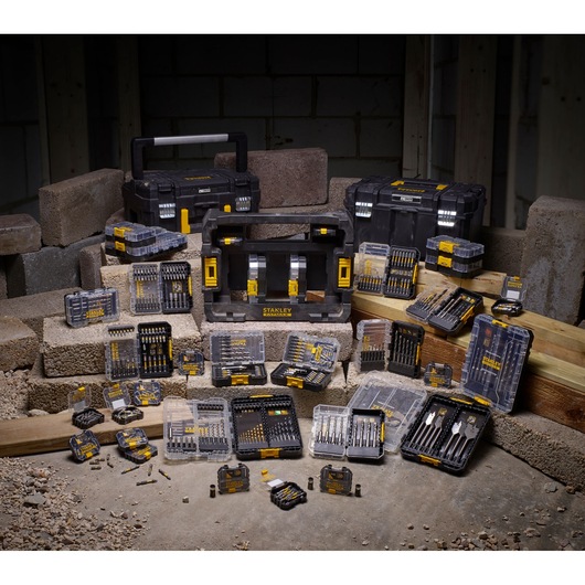 STANLEY STA88558 drill and bit kit assortment with hard cases, displayed on construction site blocks, front angle.
