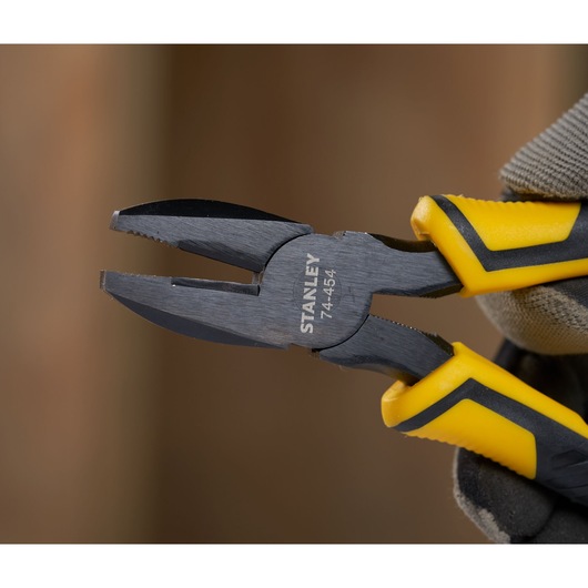 STANLEY STHT0-74454 combination pliers with yellow and black handles, close-up view.