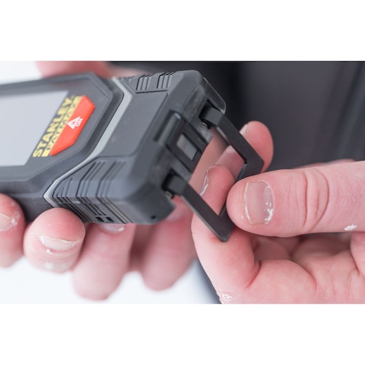 Photo of STANLEY STHT1-77142 distance measurer held in hand, showing retractable end piece.
