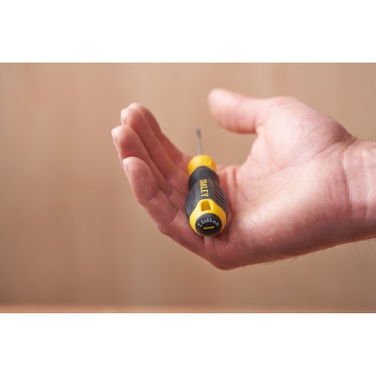 Photo of STANLEY STHT16151-0 screwdriver with yellow and black handle, held in a person's hand.