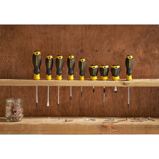 STANLEY STHT16163-0 screwdriver set with yellow and black handles, front view on wooden shelf.