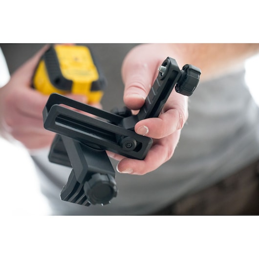 STANLEY STHT77499-1 photography accessory in hand, black adjustable mounting bracket, close-up.