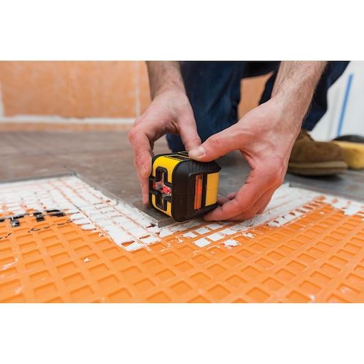 Photo of STANLEY STHT77502-1 laser level tool used for floor tiling alignment.