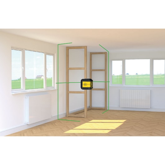 STANLEY STHT77592-1 laser level projecting green lines in a room, mounted on wooden framing.