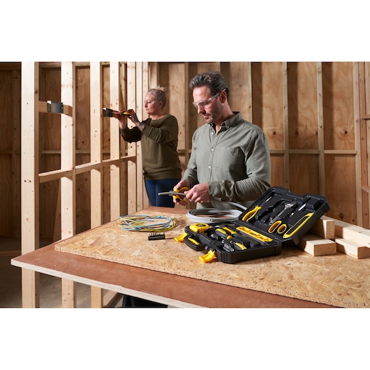 STANLEY STHT78050-1 tool kit photography with open case and tools on table, workshop setting.