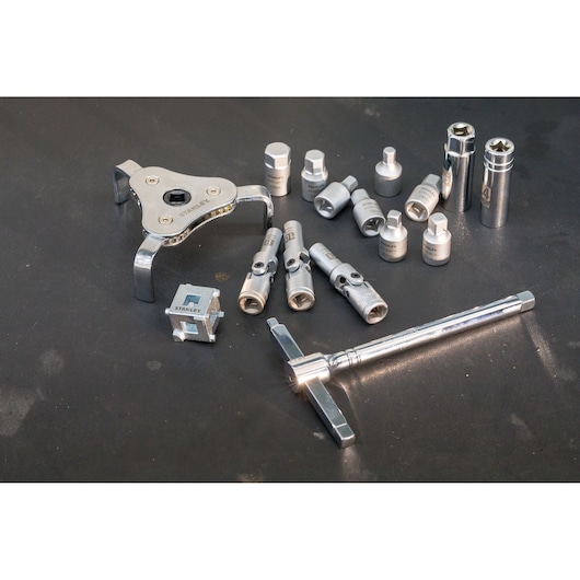STANLEY STHT80872-0 multi-piece socket and adapter set, silver metal tools on black surface, angled view.