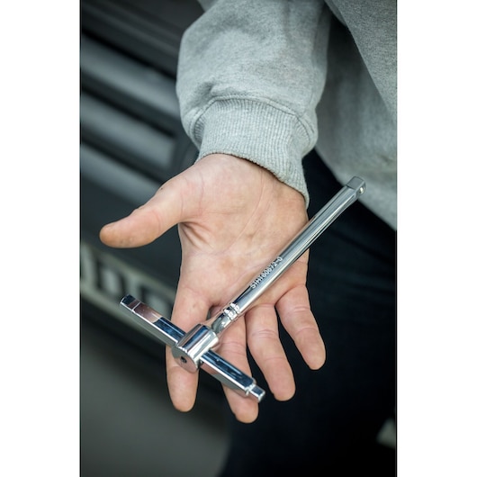 STANLEY STHT80872-0 chrome Tee handle tap wrench held in hand, close-up view.