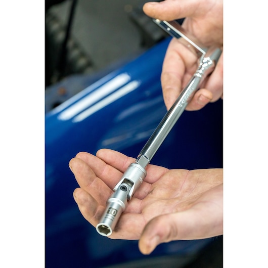STANLEY STHT80872-0 chrome socket wrench in hand, close-up, mechanics tool, photography.
