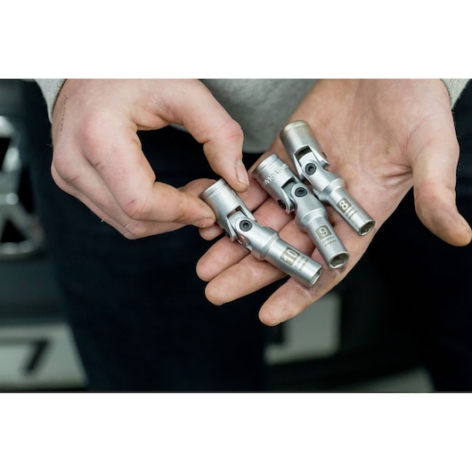 STANLEY STHT80888-0 flexible socket set in hand, silver metal, sizes 8, 9, 10 mm, close-up photo.