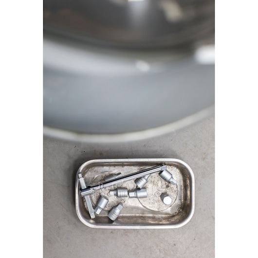 STANLEY STHT81576-0 photography of sockets and ratchet in a metal tray, top angle view.